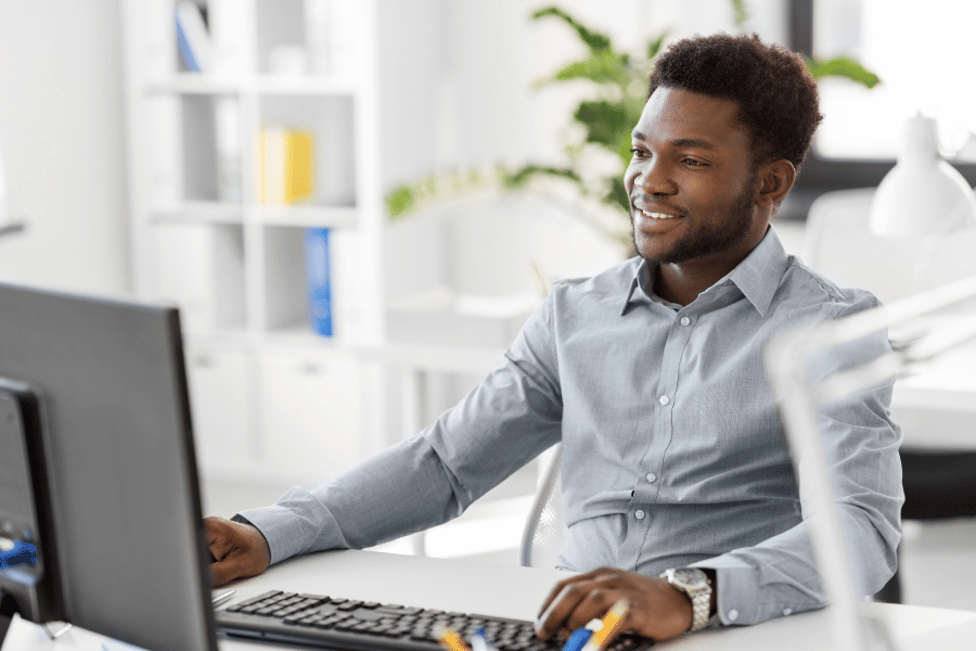 real estate agent working on computer at desk and following up with leads