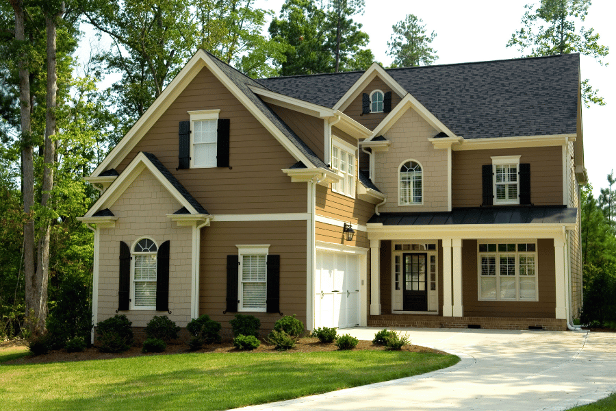 beautiful suburban home with black shutters and front porch