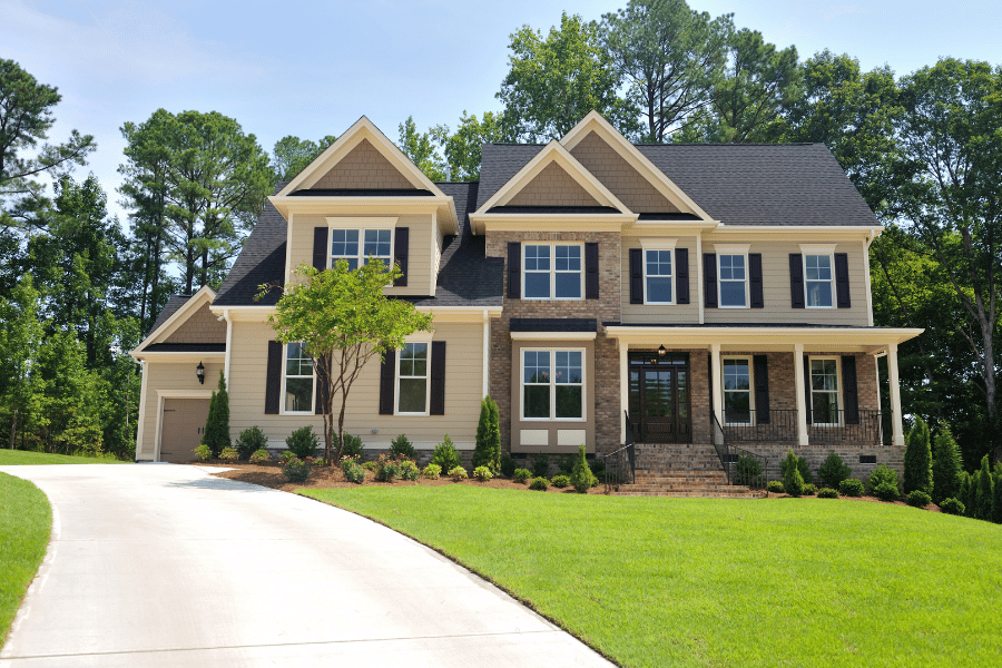 large single-family home with stone siding and long driveway