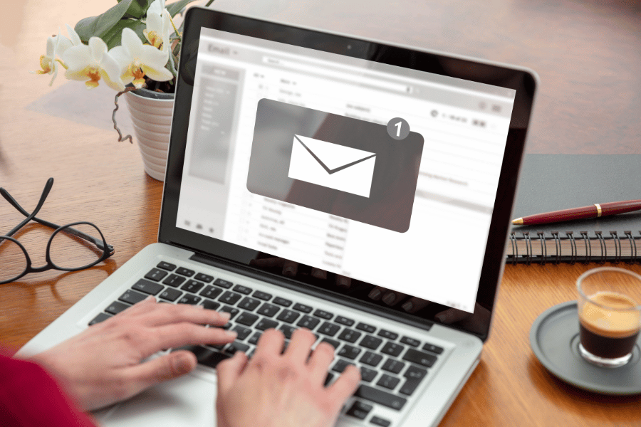 person checking email inbox on laptop for local market real estate updates