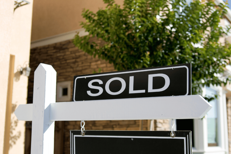 sold sign in front of home