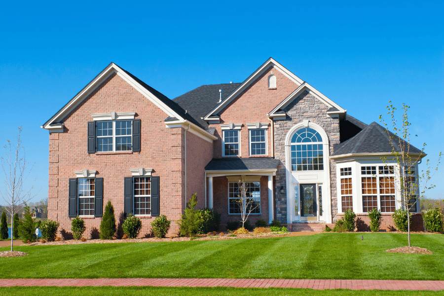 large brick single-family home with large front yard