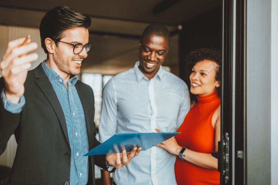 real estate agent conducting an open house with a couple