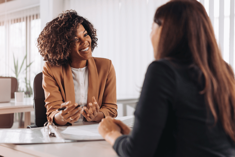part-time real estate agent meeting with a client and discussing housing options