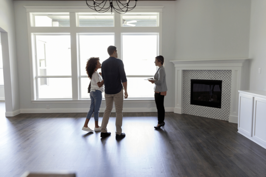 professional real estate agent working with ideal clients and showing them an open house