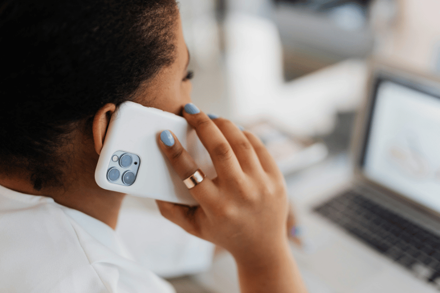 real estate agent on the phone and computer leveraging technology to scale their business