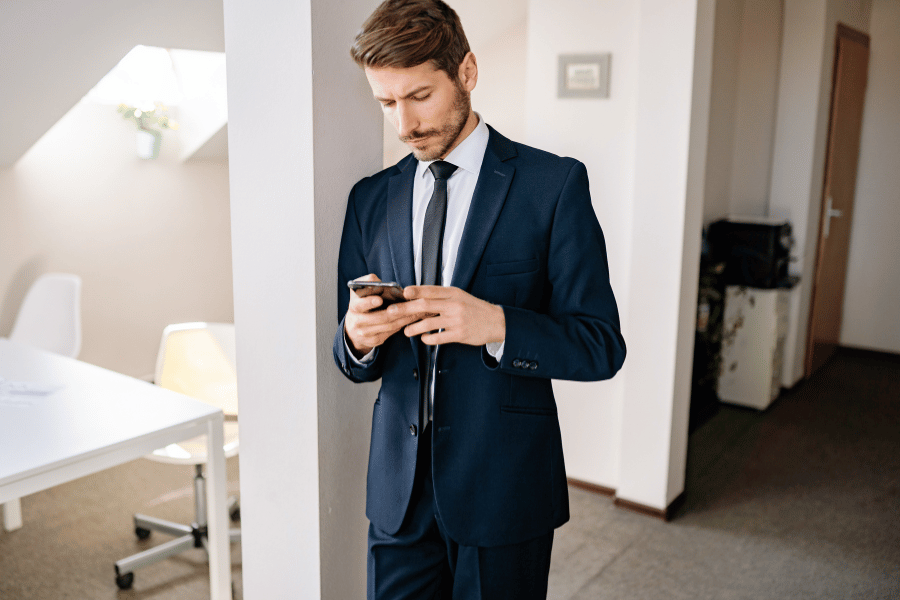 real estate agent sending out messages to clients on smartphone