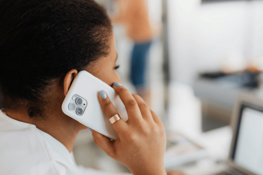 real estate agent on smartphone touching base with clients