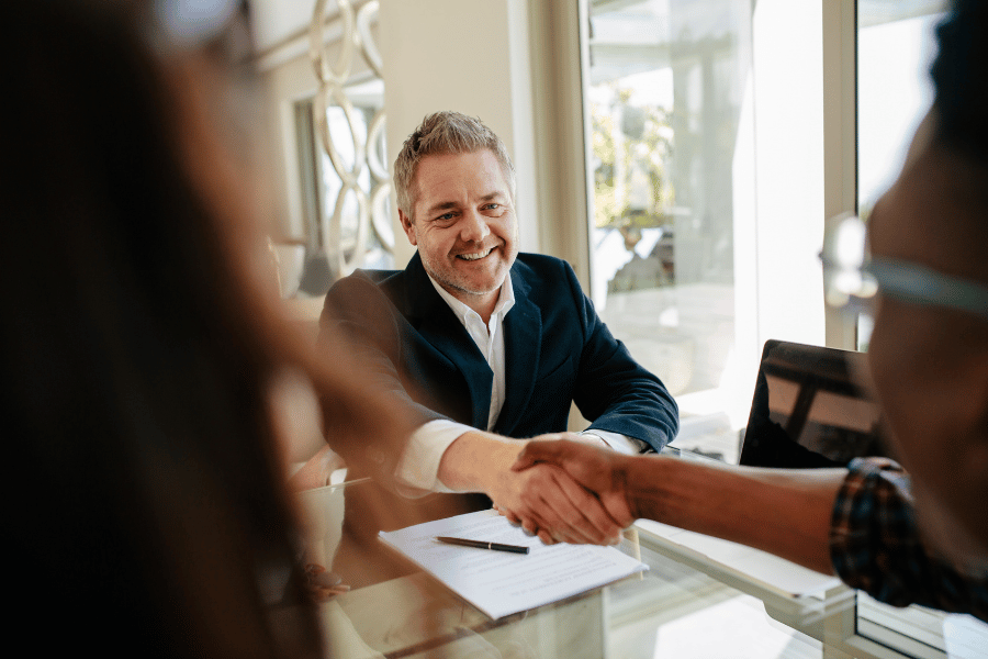realtor in a meeting and shaking hands with a client