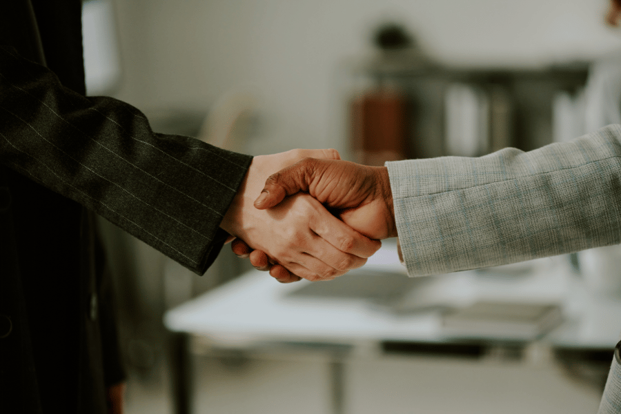 two real estate agents meeting and shaking hands