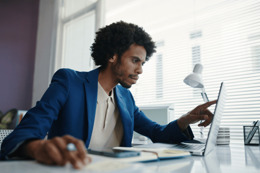 real estate agent working at a desk on the computer