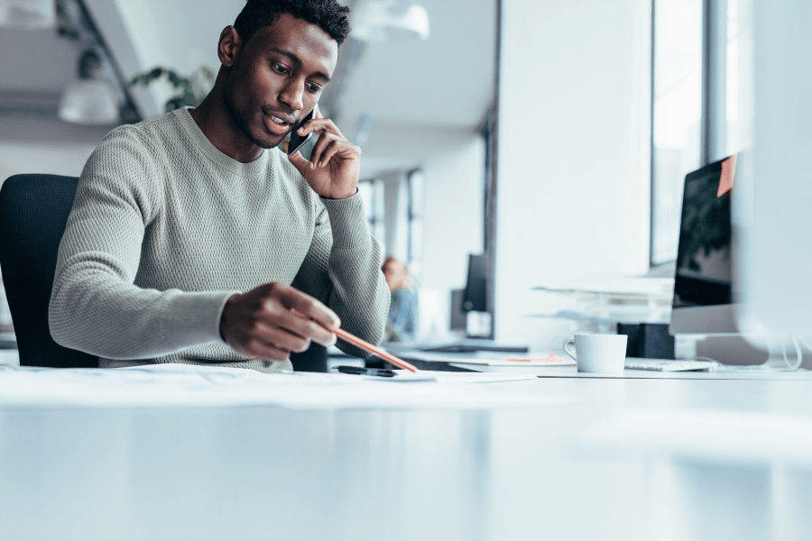 real estate agent on the phone and sitting at a desk working hard