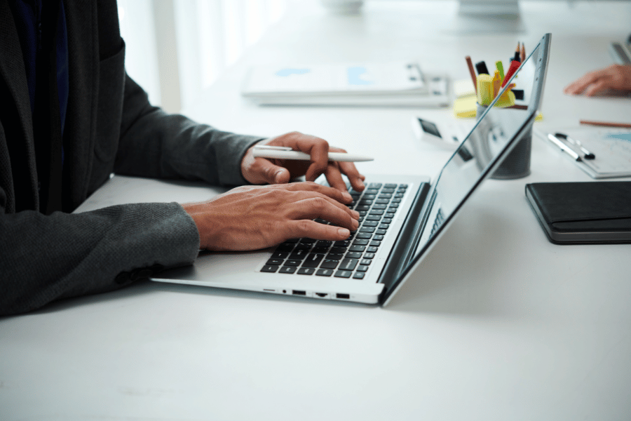 real estate professional writing a blog post on their laptop computer